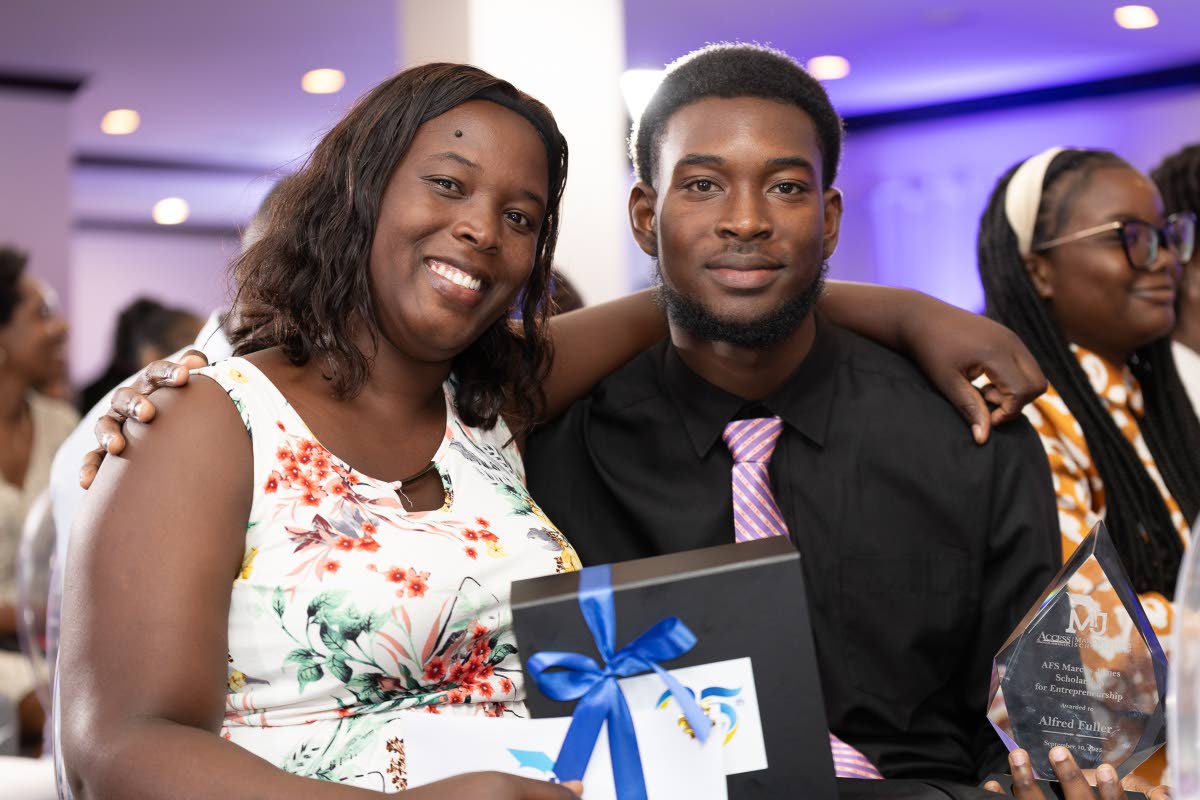 A proud moment for the inaugural recipient of the Access Financial Services Marcus James Scholarship for Entrepreneurship, Alfred Fuller (right), and his mother, Larnett Squire.