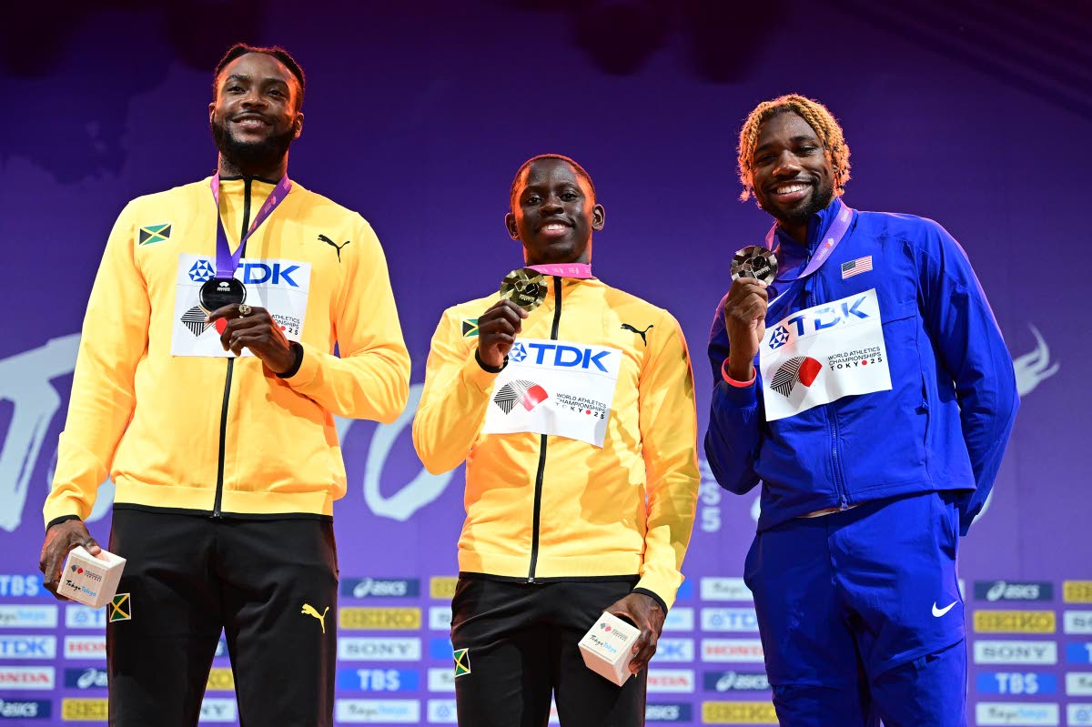 From left: Jamaica’s Kishane Thompson, Oblique Seville, and the United States’ Noah Lyles show of their respective silver, gold and bronze medals they earned in the 100 metres at the World Athletics Championships.