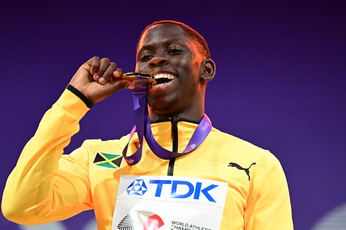 Jamaica’s Oblique Seville tests the authenticity of the gold medal he earned for winning the 100 metres at the World Athletics Championships in Tokyo, Japan.