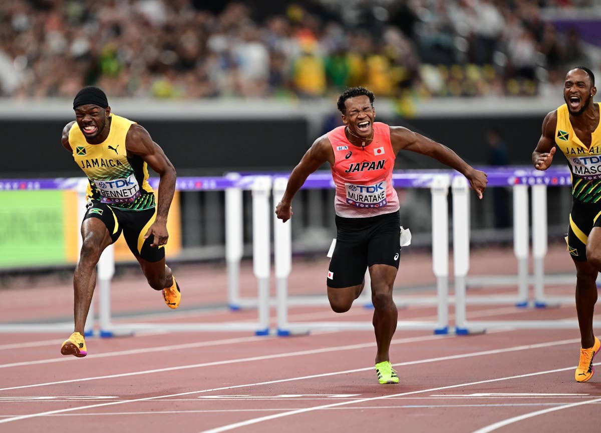 Orlando Bennett (left) and Tyler Mason (right) strain for the line as they secure the silver and bronze medals during the 110-metre hurdles final at the World Athletics Championships yesterday. Also trying to get into the picture is Japa’s Rachid Muratak