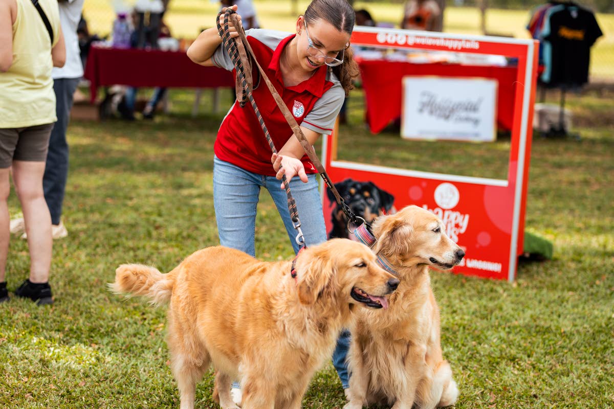 A happy Milena Esliger with two of her family’s golden retrievers, Misty and Alba.
