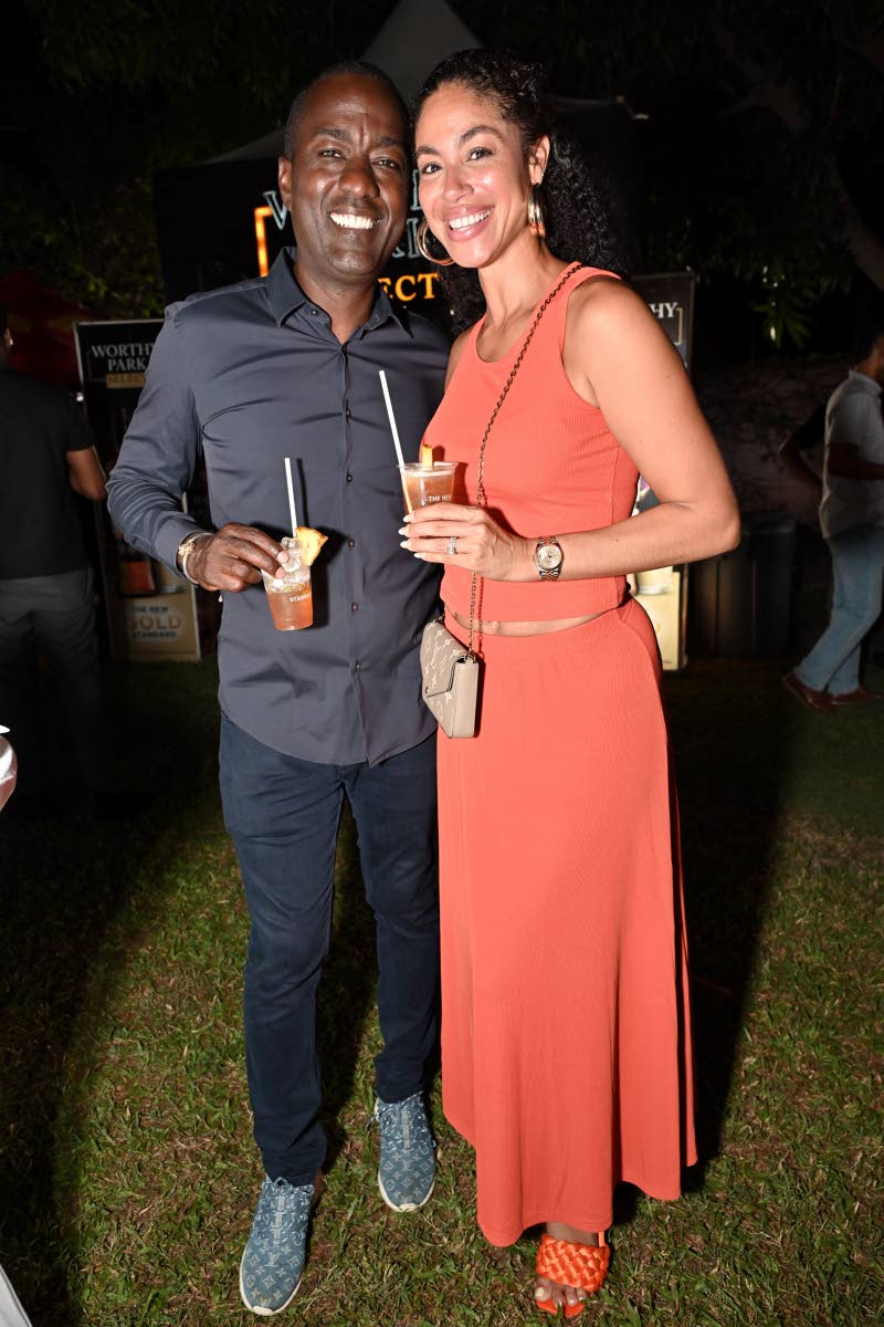 With drinks in hand, media personality Yendi Phillipps enjoys the evening’s festivities alongside her husband, Omar McFarlane.