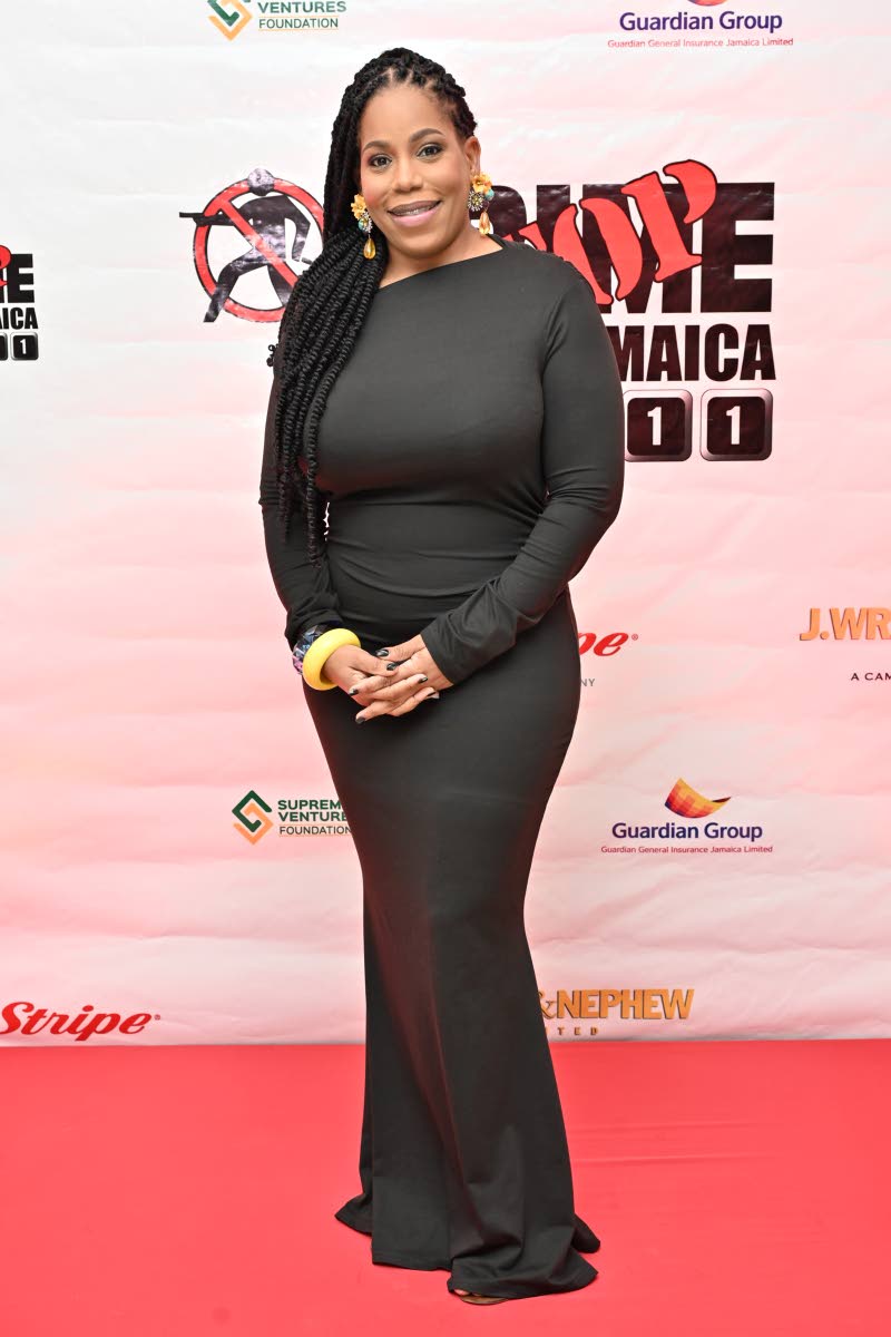 Cherise Bruce-Douglas, executive director of Crime Stop Jamaica, pairs her black long-sleeve gown with statement accessories.