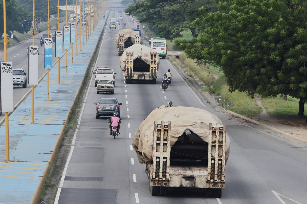 Trucks transport tanks east from Valencia, on August 27, 2025, after the government announced a military mobilization following the US deployment of warships off Venezuela. 