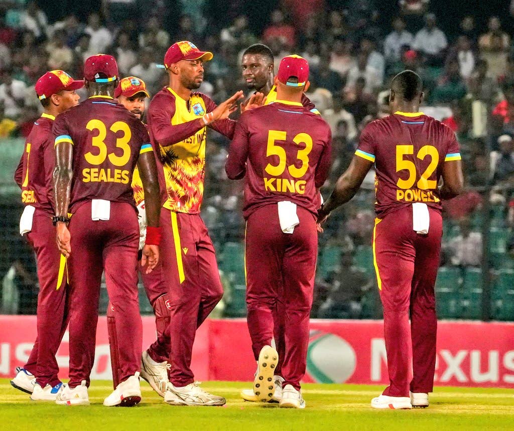 Photo courtesy CWI Media 
Jason Holder (third right) celebrates with teammates from left: Alick Athanaze, Jayden Seales, Shai Hope, Roston Chase, Brandon King and Rovman Powell after taking a wicket, during the second T20I at the Bir Sreshtho Flight Lieute