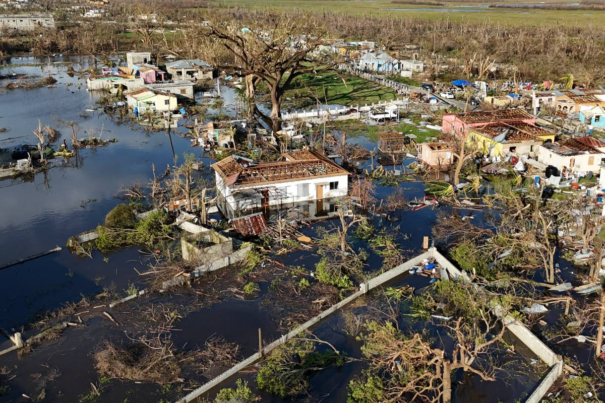 Debris surrounds damaged homes along the Black River, Jamaica, in the aftermath of Hurricane Melissa.