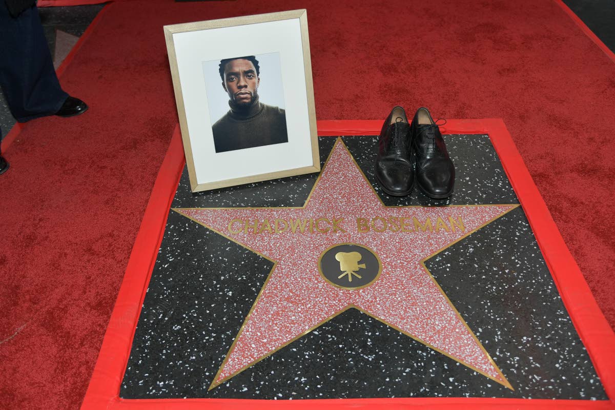 Actor Chadwick Boseman’s shoes and portrait are displayed on his newly unveiled star during a posthumous Hollywood Walk of Fame ceremony in Los Angeles on Thursday.