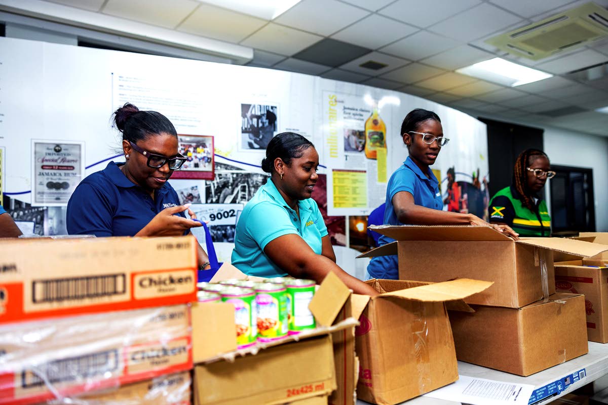 Campari staff prepare care packages for distribution to hard-hit parishes following the passage of Hurricane Melissa.