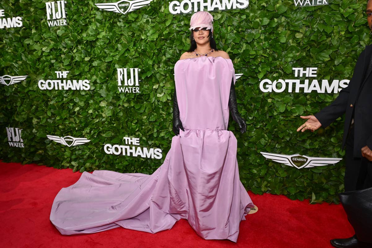 Rihanna makes an appearance in bubblegum-pink Balenciaga, paired with a feather hat and black leather gloves.