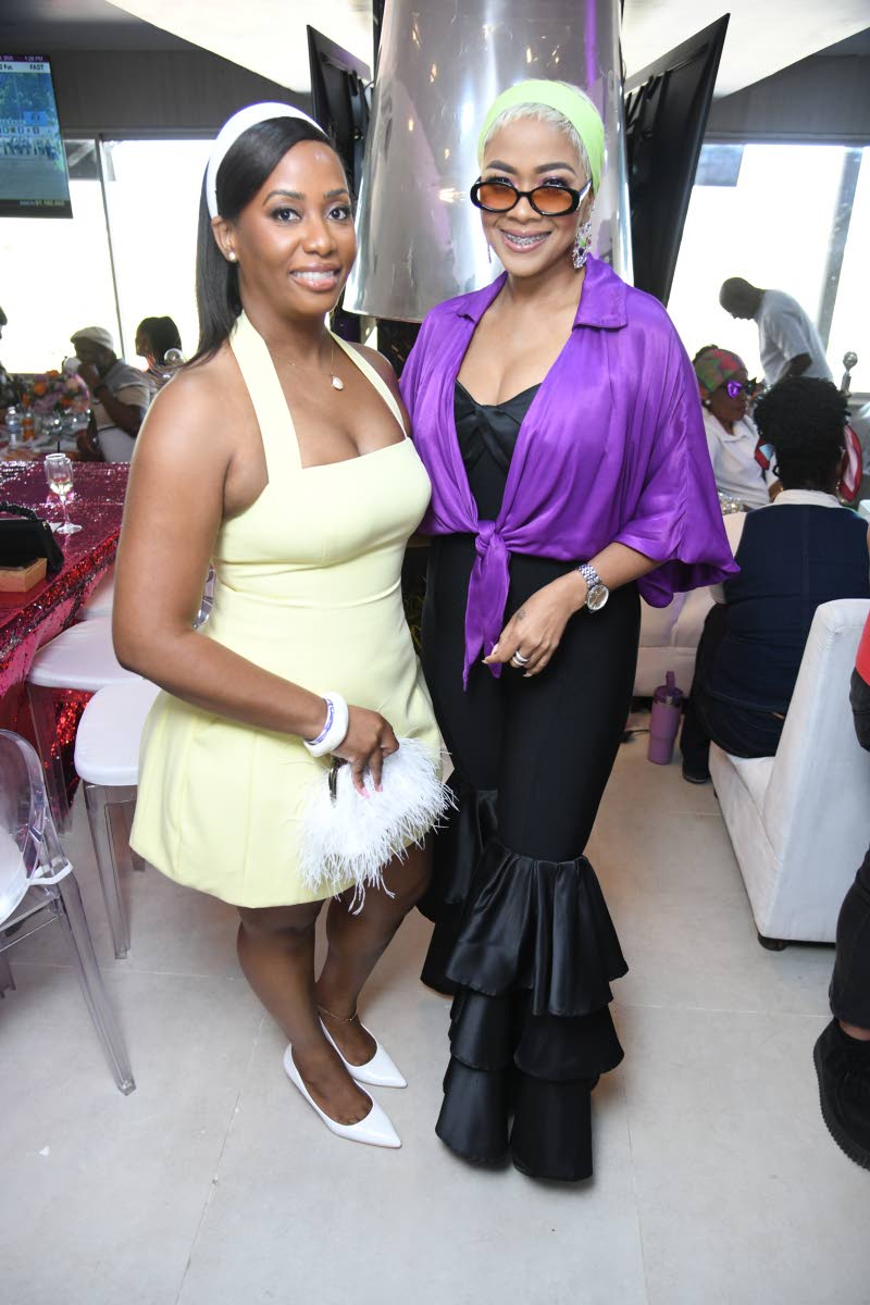 Embracing the 1970s theme in stunning fashion are Krista Fisher (left), chief executive officer of Supreme Ventures Limited, and media personality Debbie Bissoon.