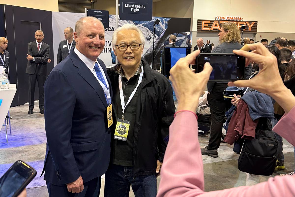 Berkshire Hathaway Vice Chairman Greg Abel poses for pictures with shareholders while touring the booths Berkshires companies set up, May 2024, in Omaha, Nebraska, USA.  