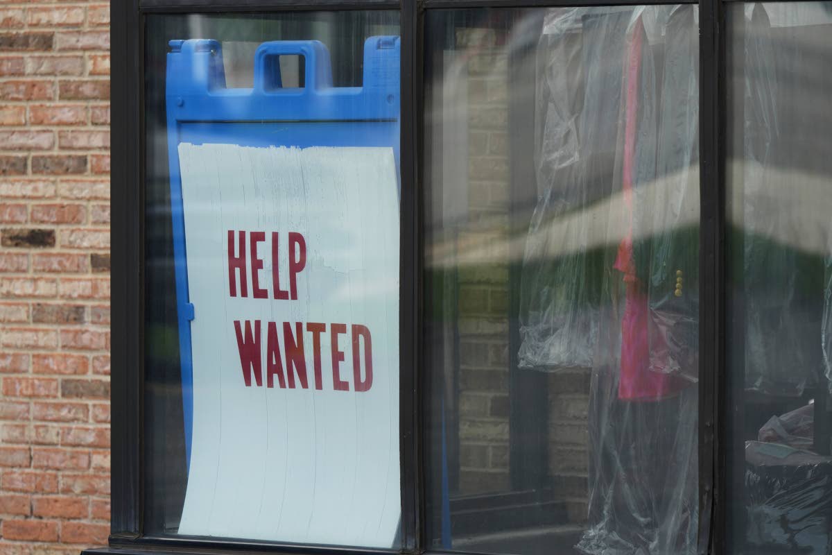 A ‘Help Wanted’ sign is displayed at a dry cleaner in Rolling Meadows, USA, in May 2025. 