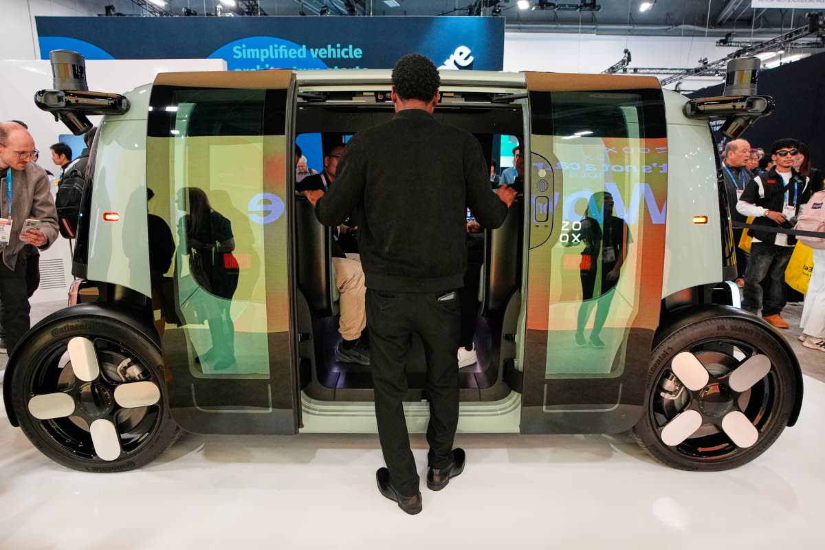 A man looks through the doors of a Zoox vehicle during the CES tech show Tuesday, January 6, 2026, in Las Vegas. (AP Photo)