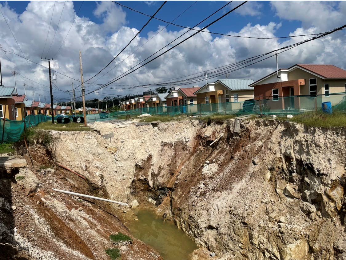 The deep pit initially caused by land caving in at The Estuary housing scheme, in St James.