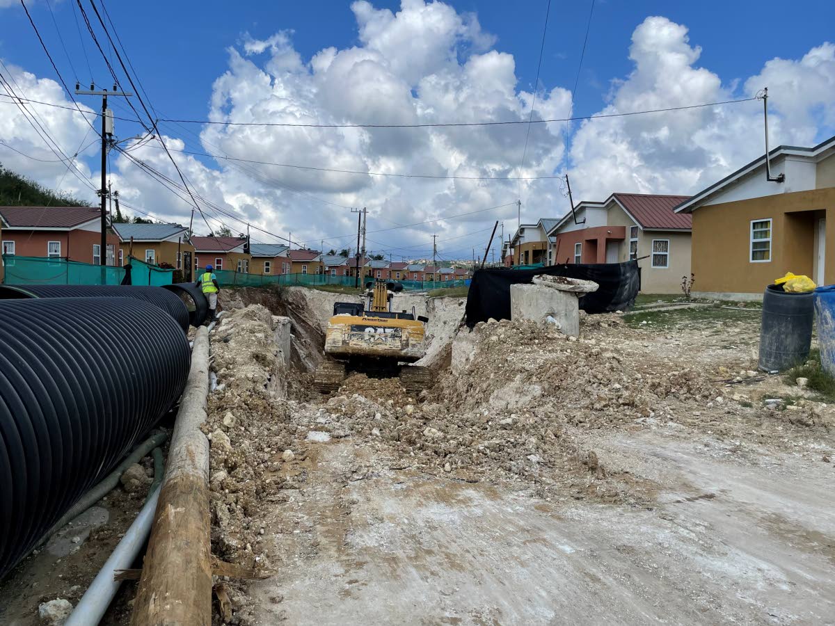The excavator working on the major land slippage in the Estuary Housing Scheme.