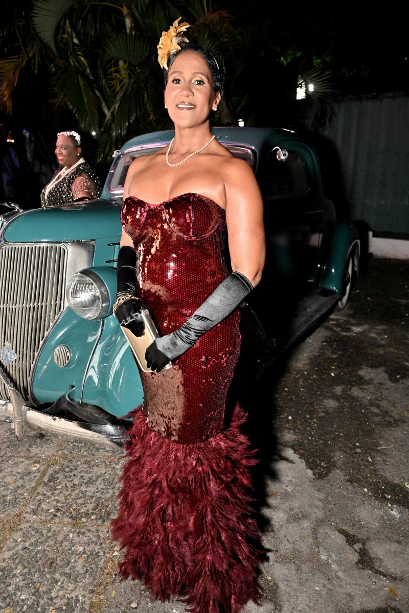 Georgia Hamilton, attorney-at-law and principal of Georgia Hamilton and Co, channels the 1920s theme in an off-the-shoulder gown, featuring a feathered hem and gloves.