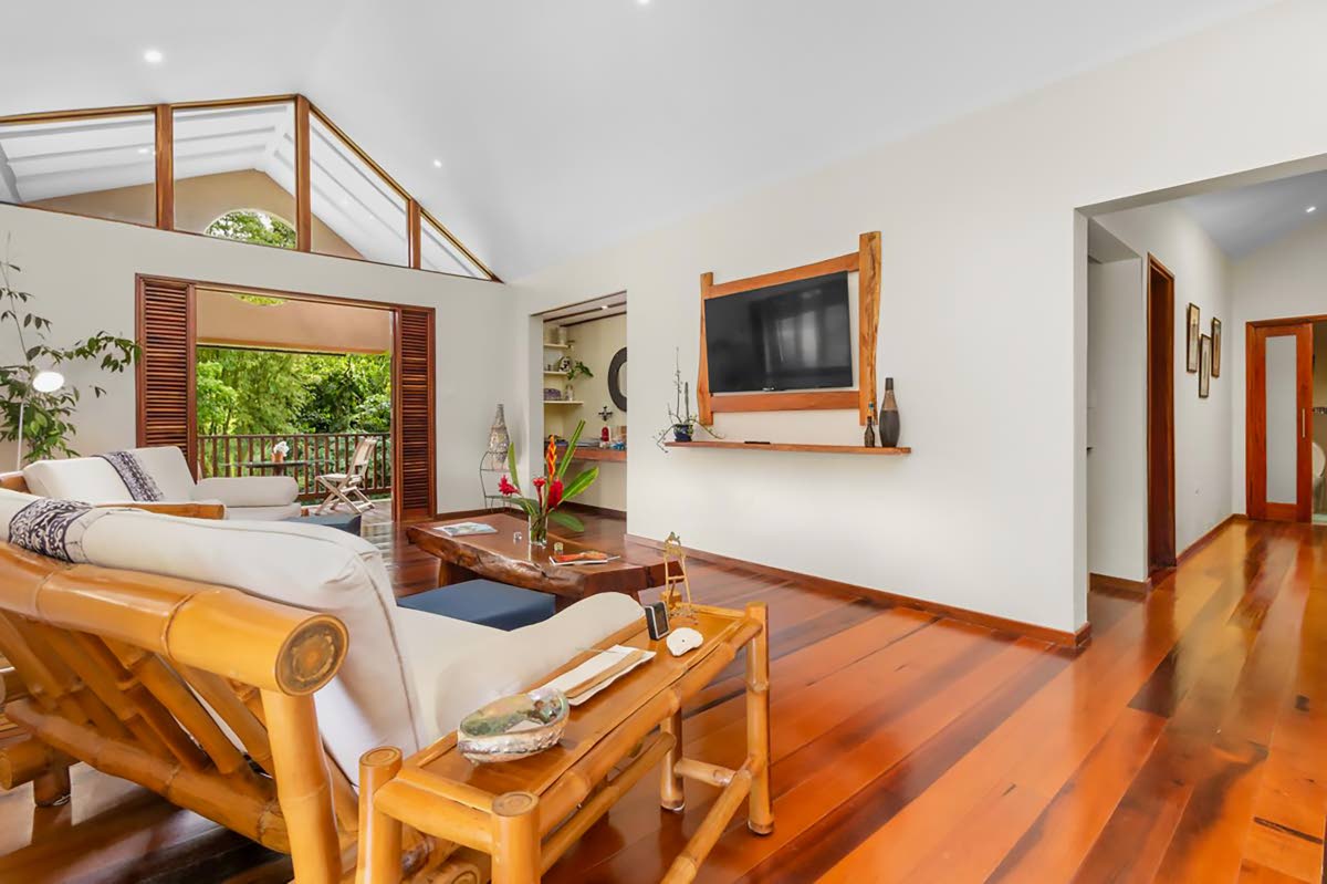 The living room offers sweeping views of the rainforest.