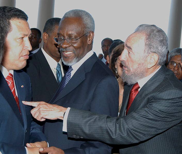 President of the Republic of Cuba Fidel Castro (right) makes a comment to President of the Bolivarian Republic of Venezuela Hugo Chávez Frias (left) much to the amusement of Prime Minister P. J. Patterson. The Heads of State were enjoying a moment in betw