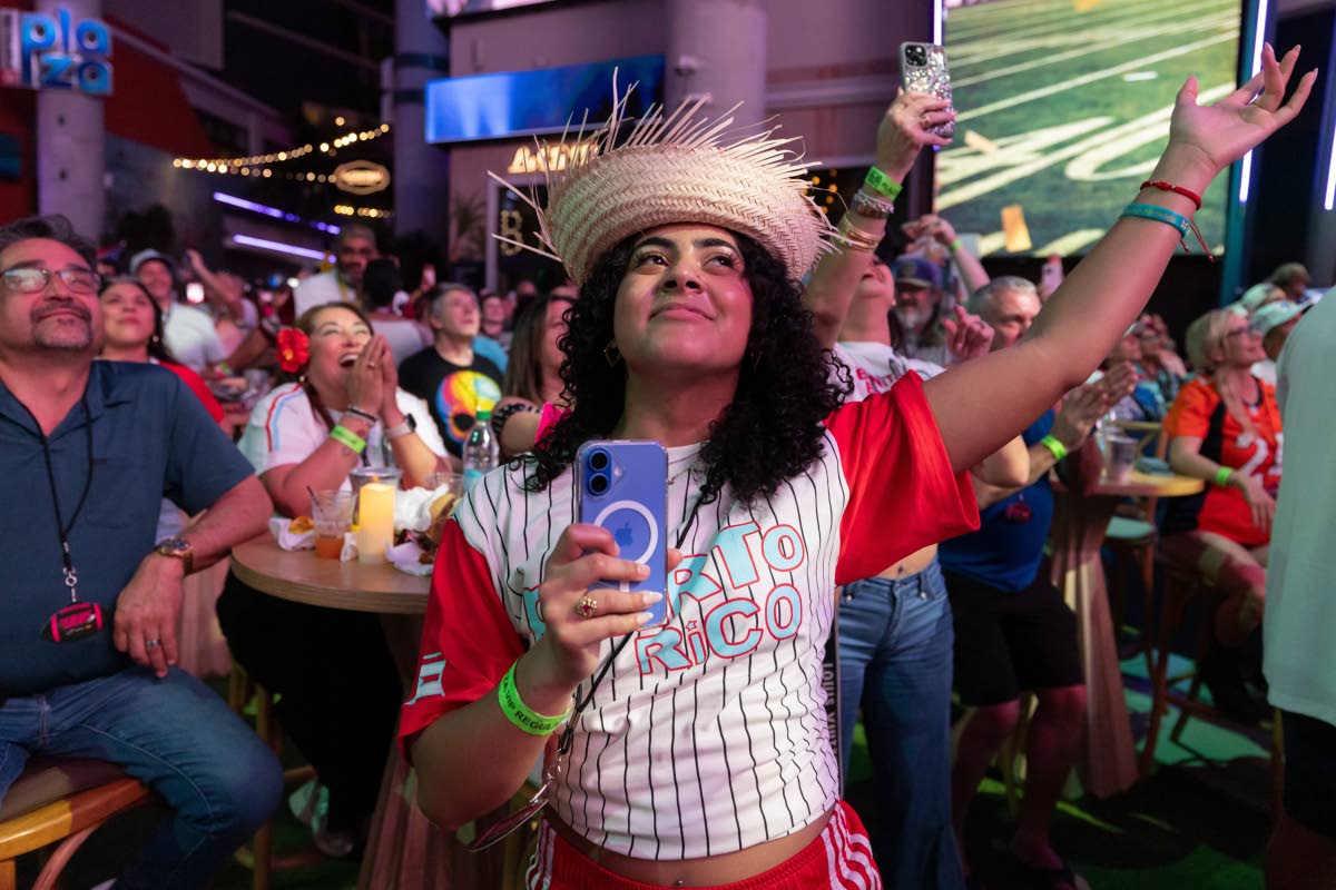 Fans in San Juan, Puerto Rico, watch Bad Bunny’s performance on television during the halftime show of the NFL Super Bowl 60 football game Sunday.