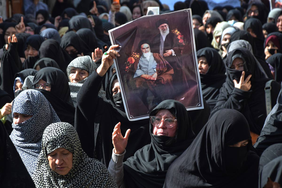 Shiite Muslims hold the portraits of Iranian leaders during a rally to condemn the killing of Iranian Supreme Leader Ayatollah Ali Khamenei, in Quetta, Pakistan.