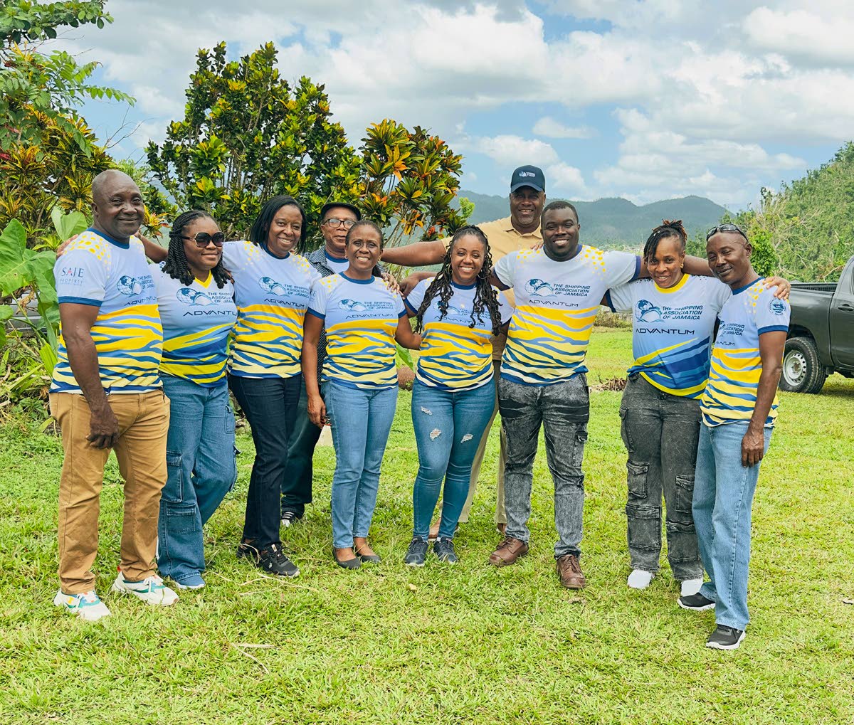 Terrence Brooks (fourth right, back row) , general manager of the Shipping Association of Jamaica with his team in Abekuta, Westmoreland, after delivering packages to residents in the area.