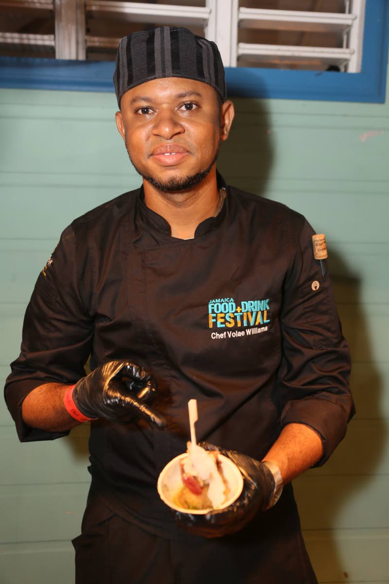Chef Volae Williams displays his smoked pimento pork belly, paired with rice and peas arancini, callaloo pesto and a jerk tamarind ginger sauce.