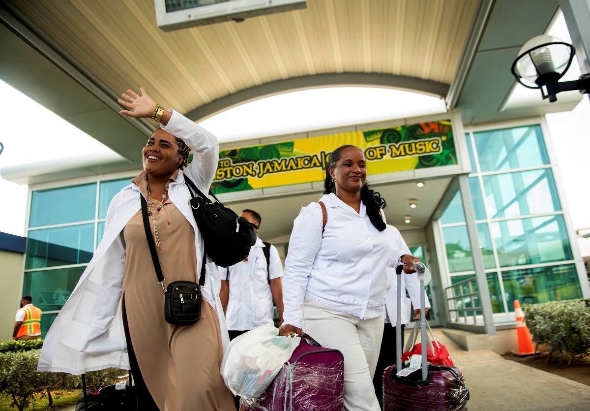 A contingent of 140 Cuban medical professionals exit the arrivals area at Norman Manley International Airport in Kingston. 