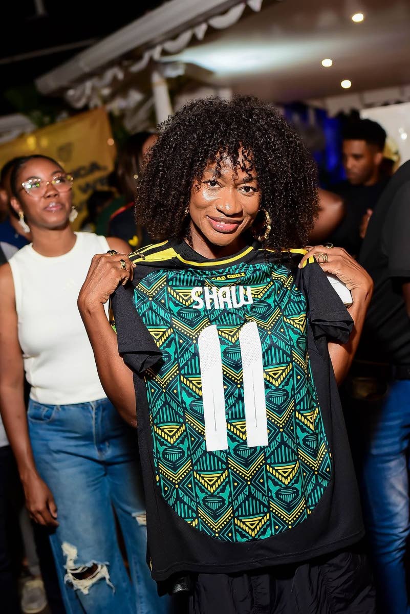 Carleene Samuels, talent manager, proudly showcases the jersey she copped.