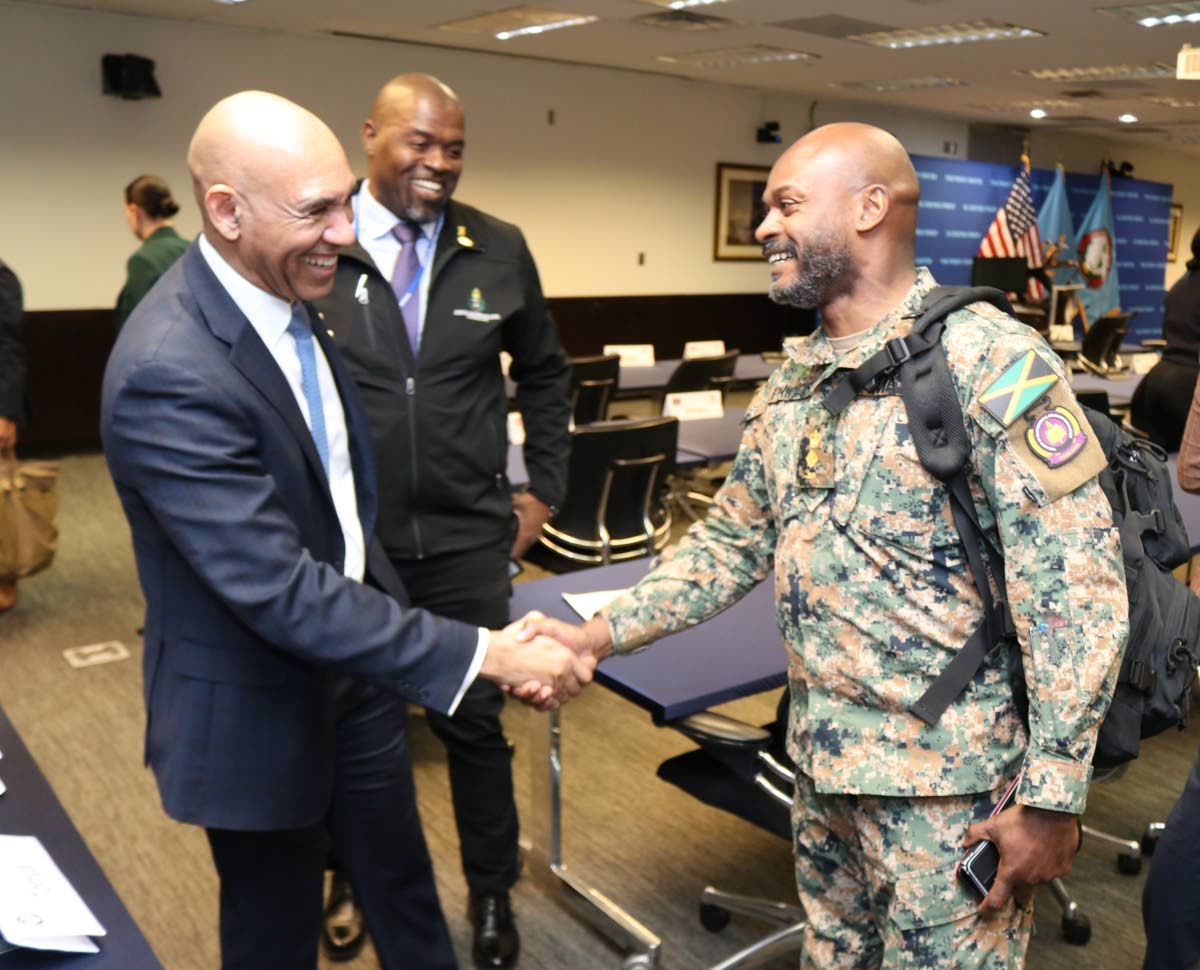Major General (Ret’d) Antony Anderson (left), Jamaica’s ambassador to the United States and permanent representative of Jamaica to the Organization of American States, greets Jamaica Defence Force Lieutenant Colonel Zavian Phipps (right), a participant