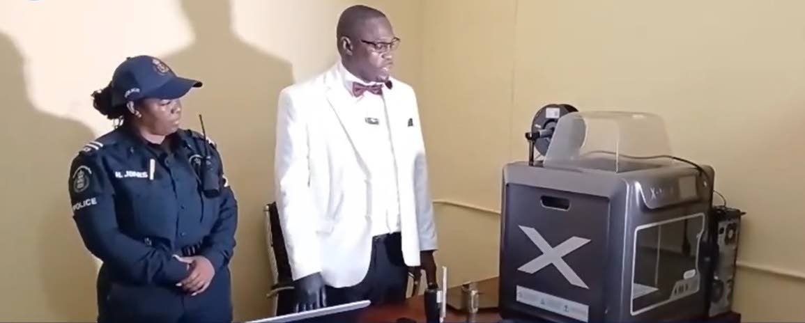 Senior Superintendent of Police Hopton Nicholson and a colleague display a 3D printer seized by law enforcement and which he said was potentially being used to manufacture suppressors (silencers) for firearms and could have been used to make so-called ‘g