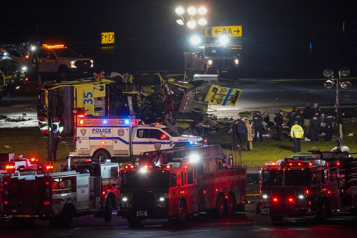 A Port Authority aircraft rescue and firefighting vehicle lays on its side off of runway 4 after colliding with an Air Canada jet after it landed at LaGuardia Airport on March 23, 2026, in New York. (AP Photo/Ryan Murphy)

