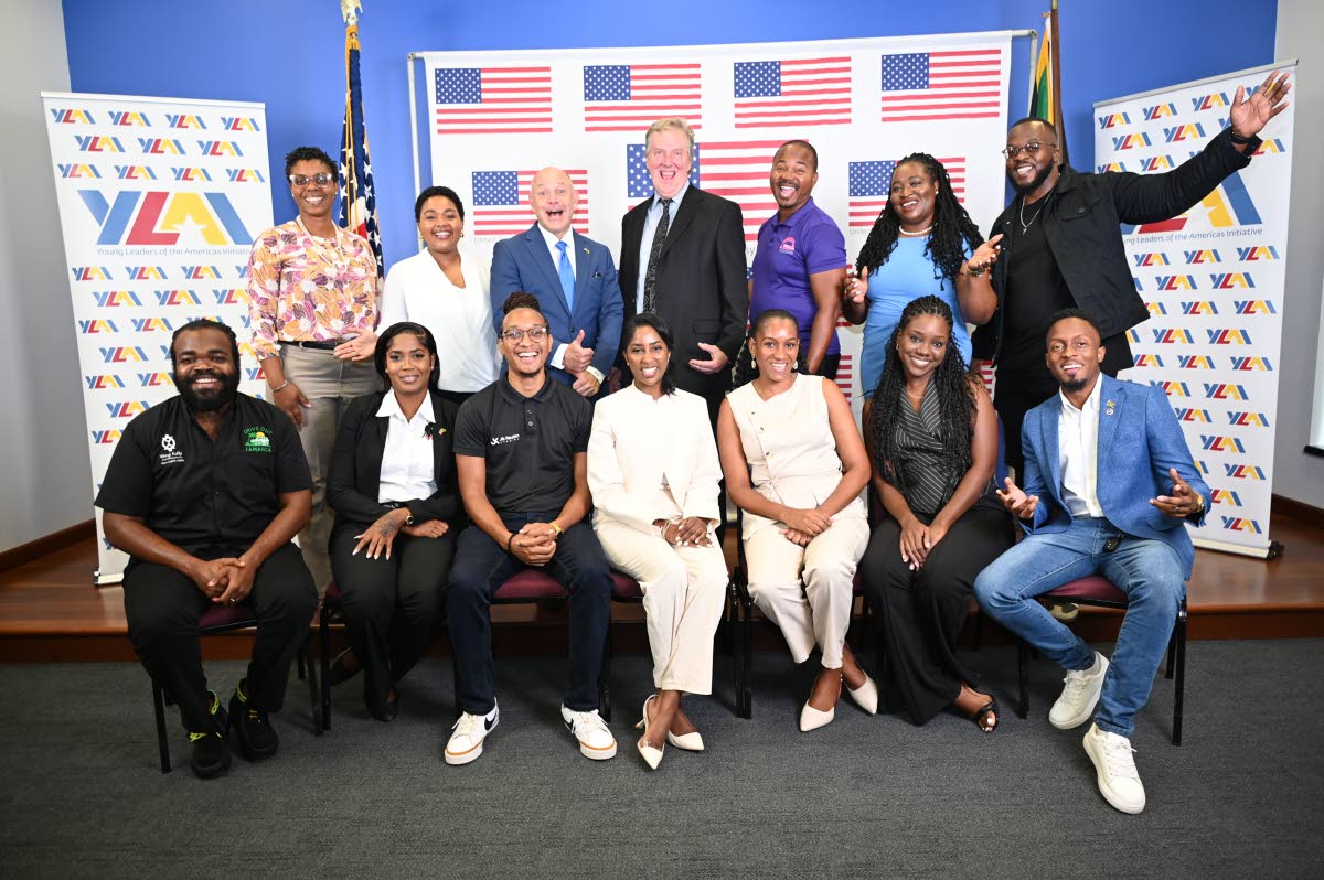 Charge d’Affaires Scott Renner (centre, standing) and United States Embassy Public Affairs Attaché, Mike Lavallee (third left, standing) are joined by YLAI alumni (back row) Latoya Rattary Ellis, Rachel Callaghan, O’Shane Ellis, Latoya West Blackwood 