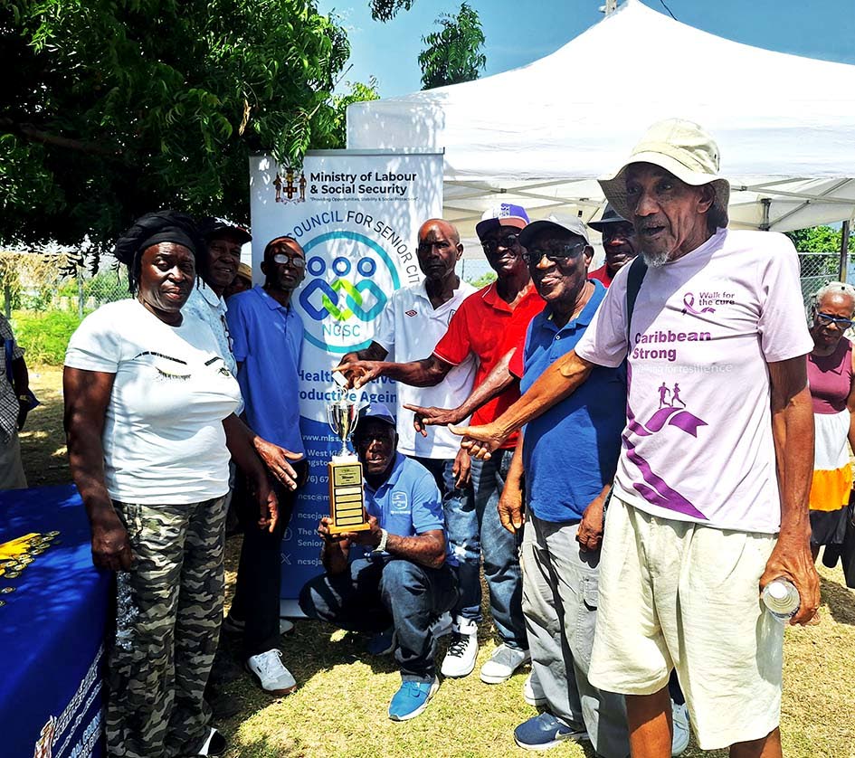 The winners of the domino competition pose for a photograph.