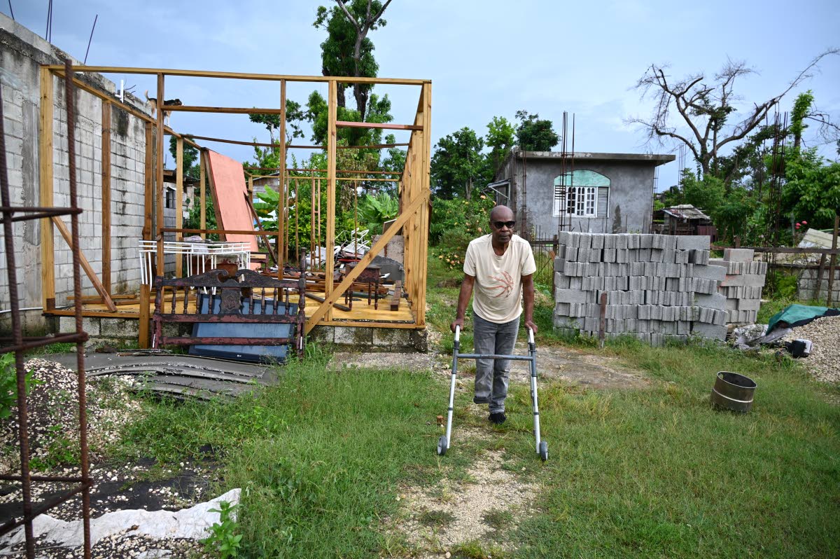 Edgar Bruce shows how badly damaged his house was and efforts in place to rebuild
