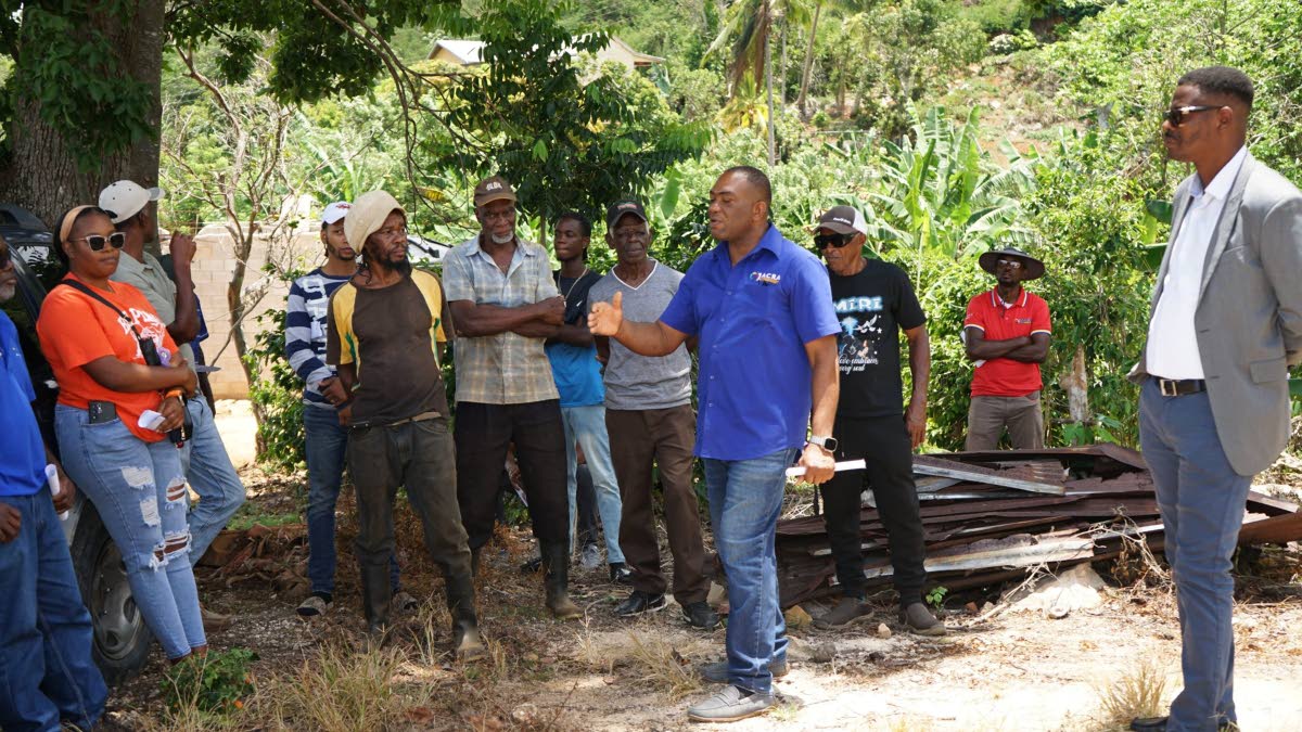Gerald Bryan (right), head of the Spices Unit at JACRA, delivers a presentation to coffee farmers during the High Mountain Coffee Revitalisation Training, highlighting best agronomic practices to improve productivity and strengthen Jamaica’s coffee indus