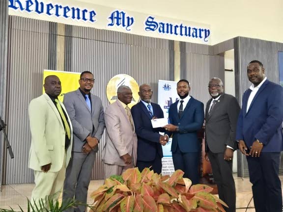 From right: Trevion Manning, acting CEO of the St James Municipal Corporation; Bishop Conrad Pitkin, custos of St James; and Mayor of Montego Bay Richard Vernon present a cheque on behalf of the St James Municipal Corporation to Pastor Delgado Black and Pa
