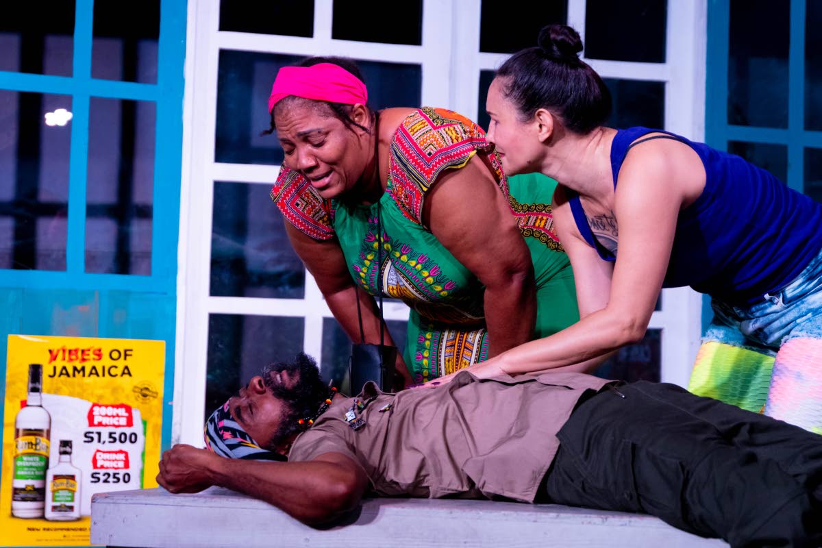 Dahlia Harris’ Pearl, a fervent Christian, and Arlene (right), played by Maylynne Lowe, the owner and barkeeper of the bar in which the play is set, anxiously check on Jah Jah Royal, played by Everaldo Creary. 
