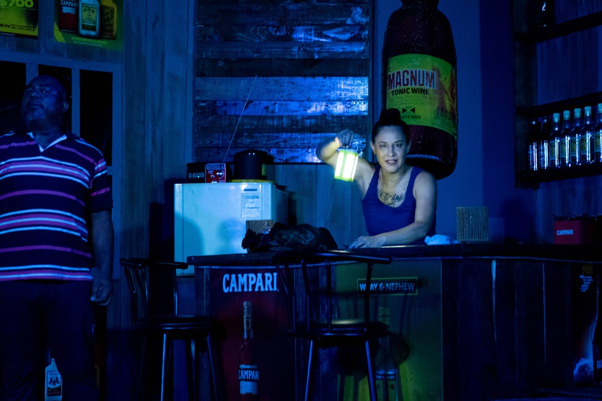 Arlene (right), played by Maylynne Lowe, holds a lantern as Parnell, played by Tesfa Edwards, looks on. 