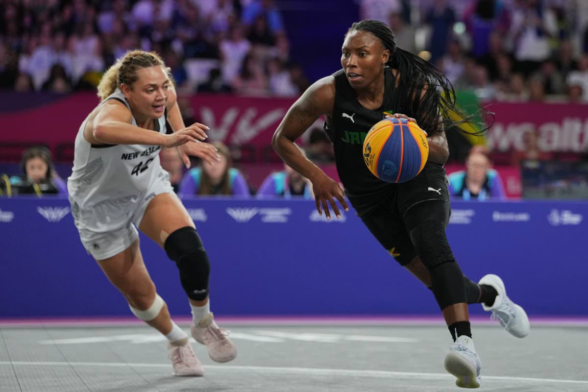 Jamaica’s Tiffany Reynolds dribbles the ball as New Zealand’s Ella Fotu defends in the women’s 3x3 basketball Bronze medal game at the Commonwealth Games in Glasgow, Scotland, yesterday.