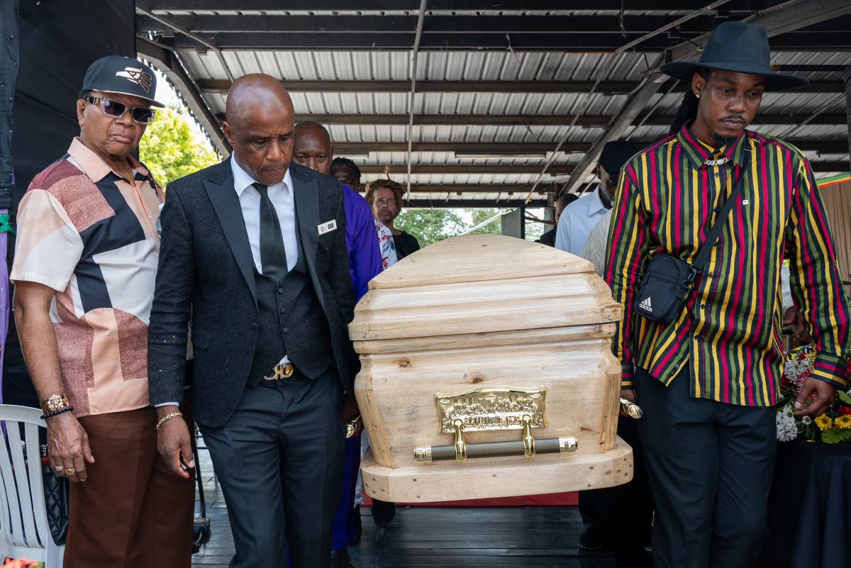 Funeral director Peter Perry (second left) and Rasheem Cole, Stranger Cole’s grandson, lead the pallbearers as entertainment industry insider Copeland Forbes looks on.