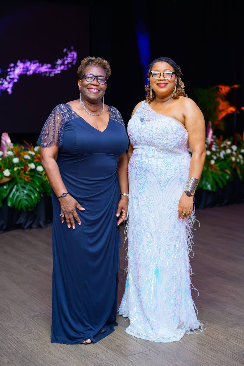 Former Director of Public Prosecutions Paula Vanessa Llewellyn (left) pauses for a photo with Miss Anieta Bailey, community relations education officer for Region 5 of the Ministry of Education, Skills, Youth and Information.