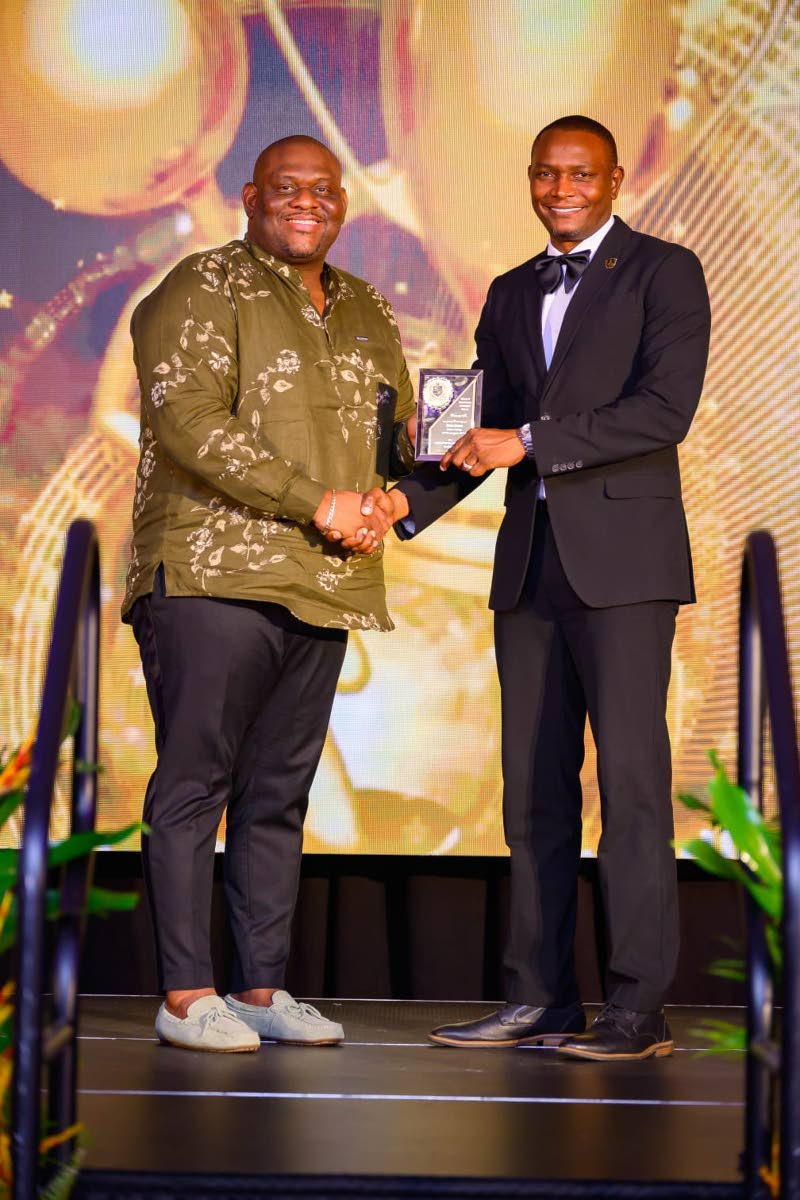 Senator Marlon Morgan (left), parliamentary secretary in the Ministry of Education, Skills, Youth and Information, presents the Outstanding Leadership in Education Award to Dr Mark Smith, principal of Munro College and immediate past president of the Jamai