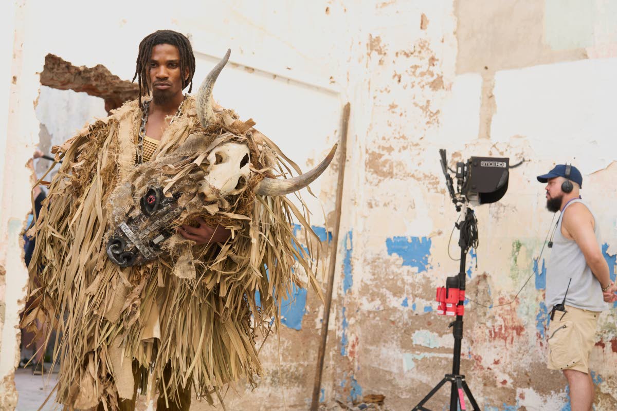 Between filming scenes for a Jonkonnu parade in downtown Kingston for ‘Possession’ – which debuts this Thursday on Sky TV in the United Kingdom – costumed actor Sheldon Shepherd and the limited series’ director, Storm Saulter, pause for a portrai