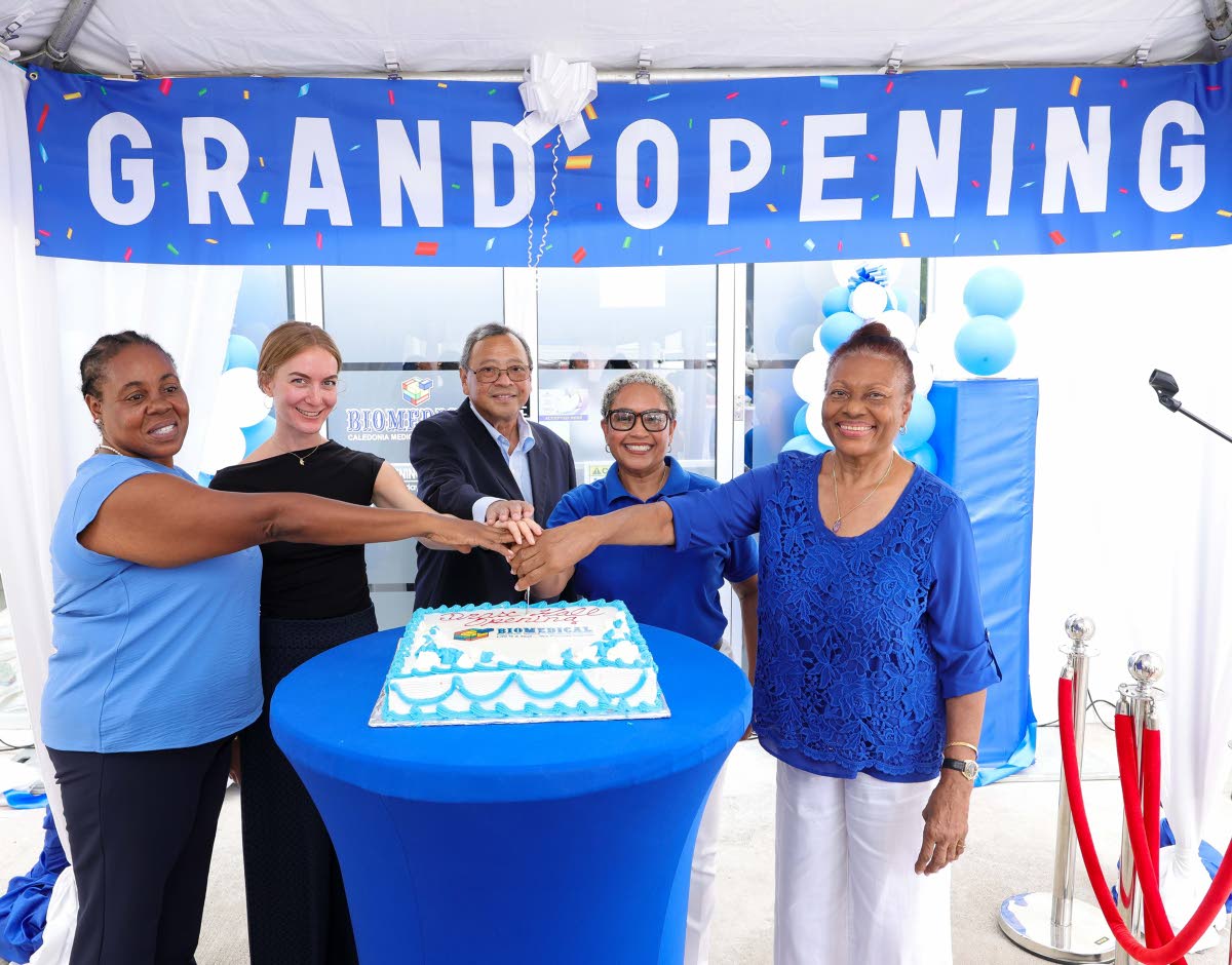 From left, directors Sonia Richards Malcolm, Shannon Boorman-Vaz, Dr Edward Chung, Helen Christian and Linda Woolery cut the celebratory cake at the July 14 ribbon-cutting ceremony marking the opening of Biomedical’s Drax Hall Collection Centre in St Ann