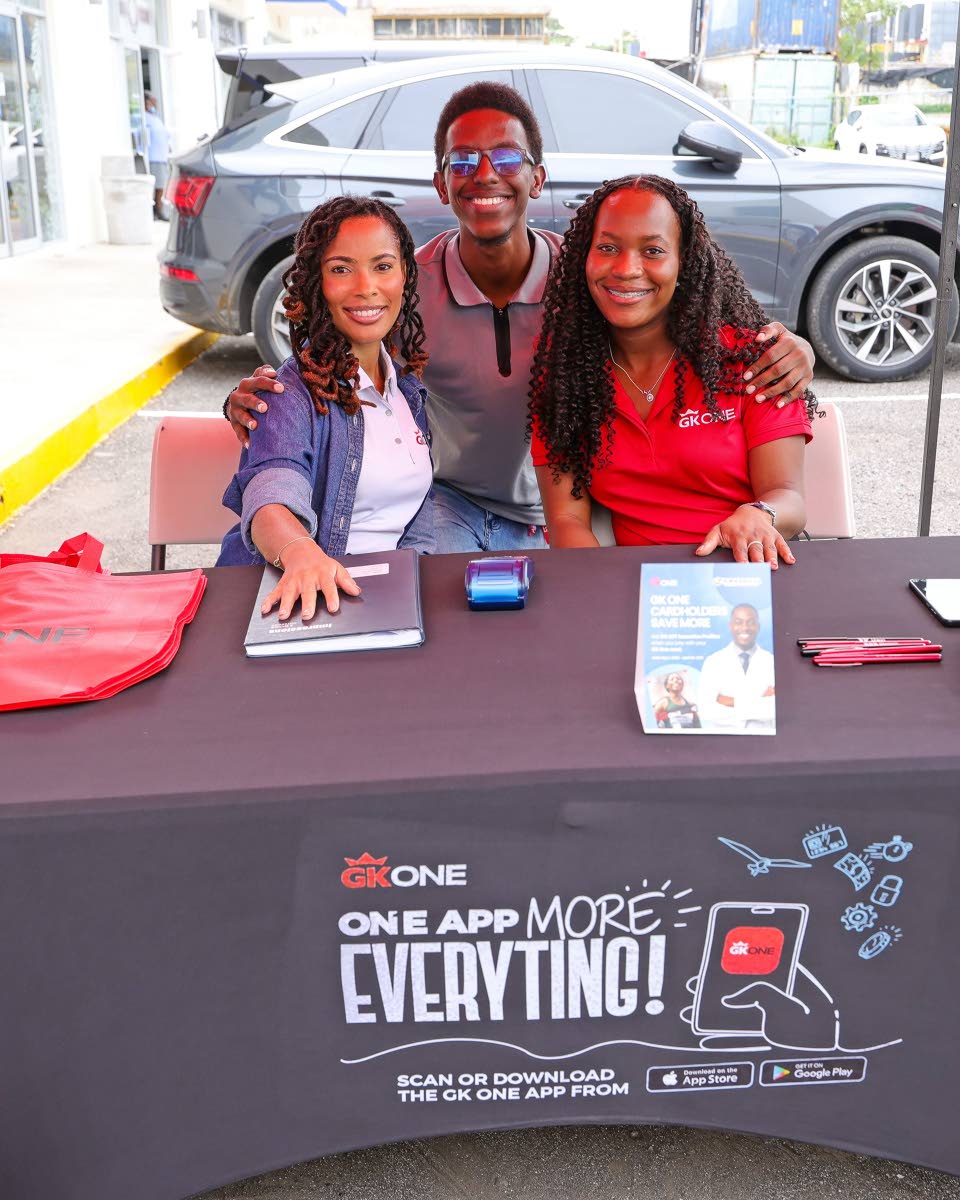 From left: Members of th,e GK One team: Anika Crawford, product owner, Fintech Products; Justin Brooks, marketing intern and Shari Webb, marketing consultant, make time for a photo op after registering persons for their GK One card which provides a five pe