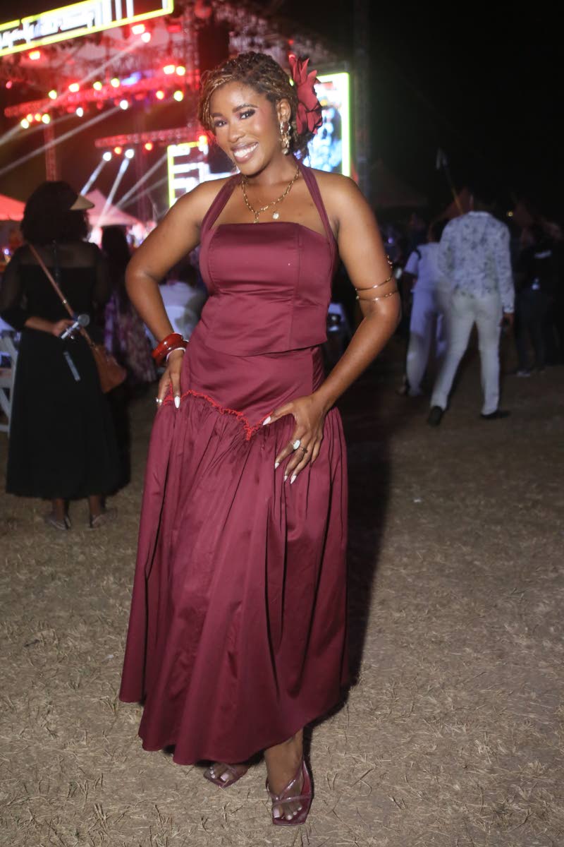 Zaneta Scott, event producer and manager, special projects at the National House Trust, dons a burgundy halterneck maxi dress.