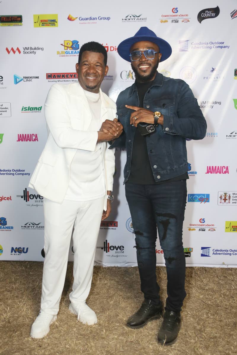 Gospel stars Papa San (left) and Kevin Downswell pause for a photograph backstage at the Come Alive: A National Call to Worship concert held Saturday at King’s House East Lawn.