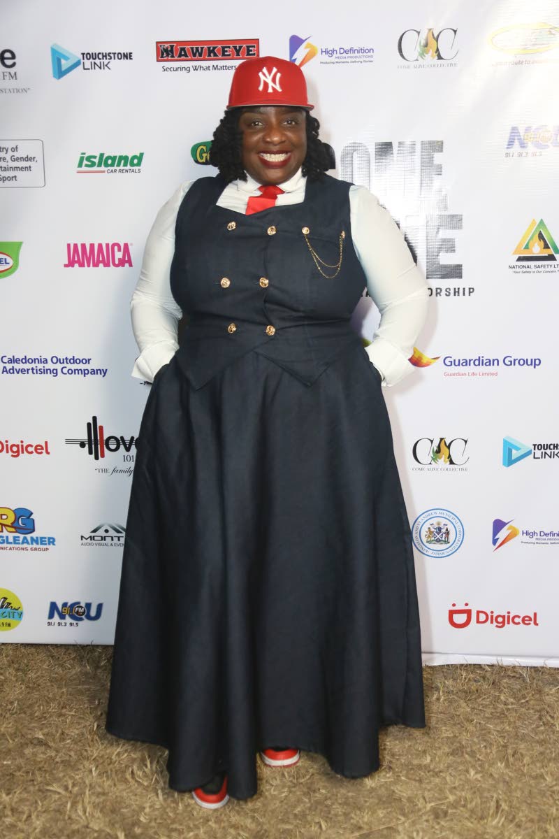 Petra Kaye styles a button-down suspender dress with a white shirt, red tie and a red New York Yankees cap.