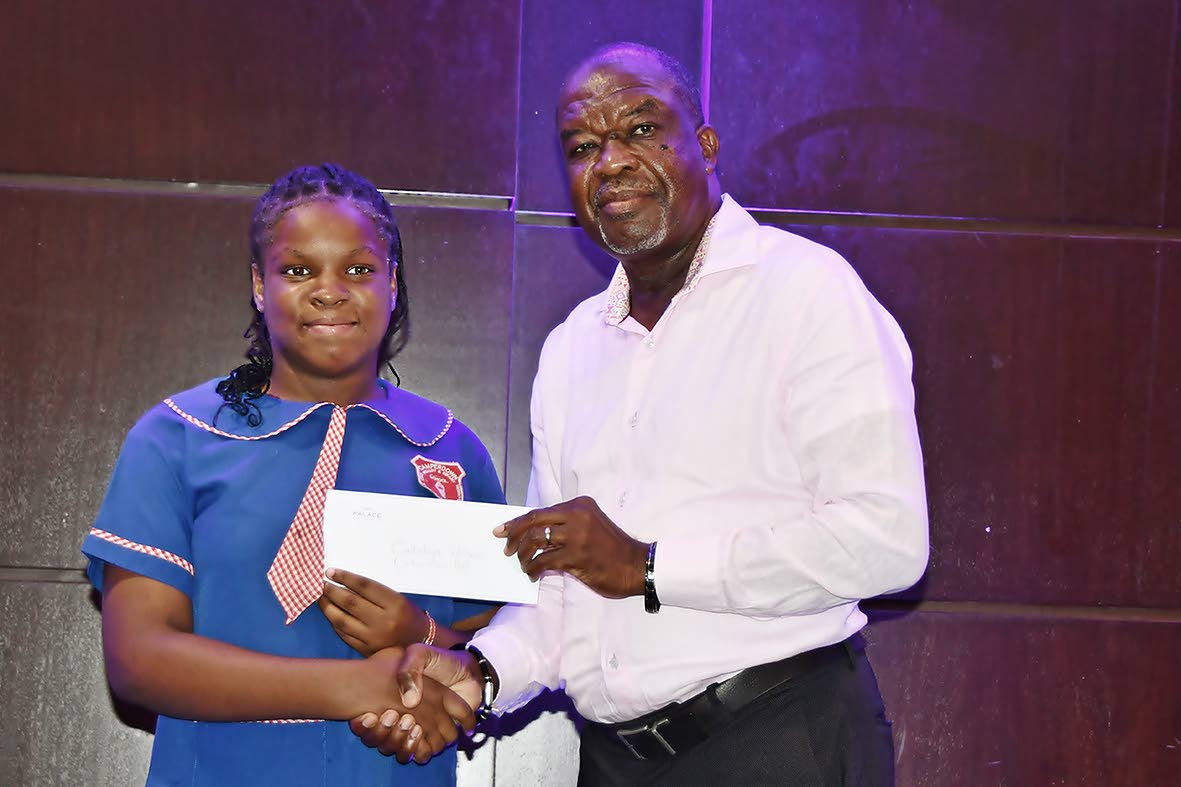 Cataleya Wilson accepts her grant from Moon Palace Vice-President Clifton Reader. Wilson, a graduate of Camperdown Primary School in St Ann, will begin studies at Ocho Rios High School in September.