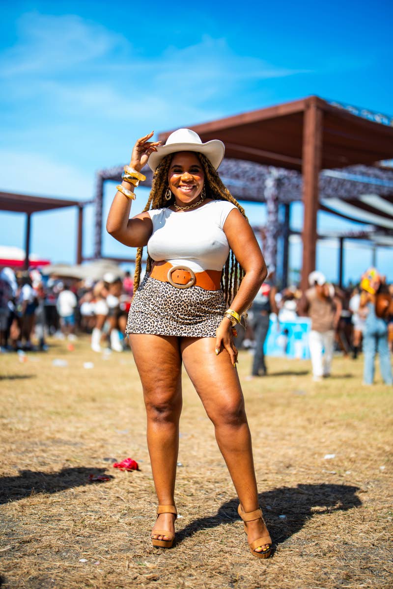 Media personality and host Daindra Harrison tipped her hat for the camera, pairing a white T-shirt with a printed mini and statement belt.